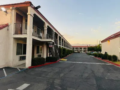 an empty parking lot in front of a building at Casa Blanca Hotel - Azusa, Los Angeles in Azusa