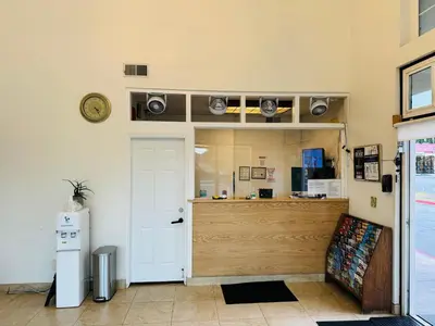 a room with a door and a counter with speakers at Casa Blanca Hotel - Azusa, Los Angeles in Azusa
