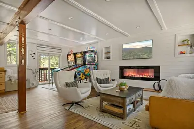 a living room with two chairs and a fireplace at Larks Nest in Big Bear Lake in Big Bear Lake