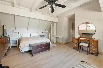 a bedroom with a bed and a dresser and a mirror at Sunset Spectacular - Multi-level haven with water views! Incredible for 4th of July! in Big Bear Lake