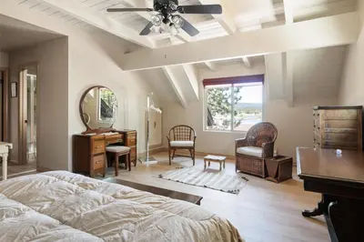 a bedroom with a bed and a dresser and a mirror at Sunset Spectacular - Multi-level haven with water views! Incredible for 4th of July! in Big Bear Lake