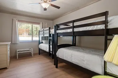 two bunk beds in a room with a ceiling fan at Sunset Spectacular - Multi-level haven with water views! Incredible for 4th of July! in Big Bear Lake