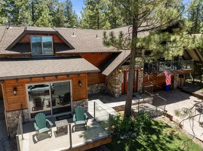 a house with a deck with chairs on it at Sunset Spectacular - Multi-level haven with water views! Incredible for 4th of July! in Big Bear Lake