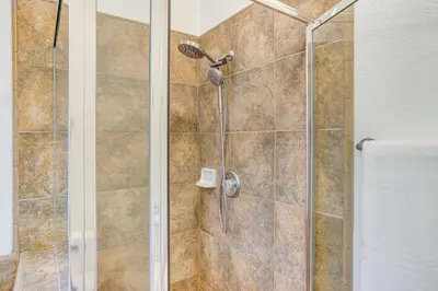 a bathroom with a shower with a glass door at Hesperia Home Near Mojave River and Hiking Trails! in Hesperia