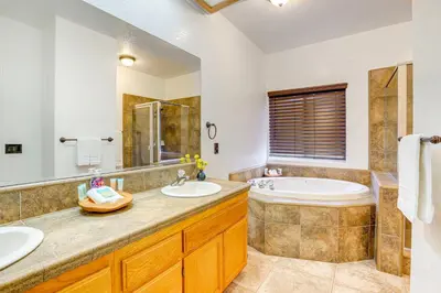 a bathroom with two sinks and a tub at Hesperia Home Near Mojave River and Hiking Trails! in Hesperia