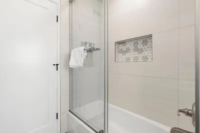 a shower with a glass door in a bathroom at Spacious 3BR Home Near Disneyland & Knotts Berry Farm in Fullerton