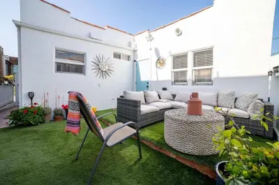 a patio with a couch and a table and chairs at Sea View, Flower Garden, AC, WD, Renovated in Hermosa Beach