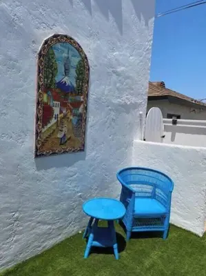 a blue stool and a painting on the side of a building at Sea View, Flower Garden, AC, WD, Renovated in Hermosa Beach