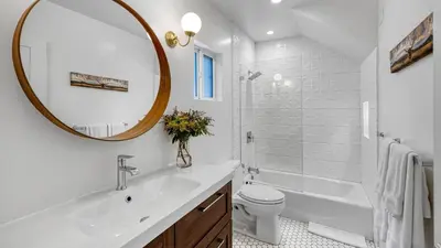 a bathroom with a sink and a toilet and a mirror at 5 Units in Heart of Hollywood Remodeled Art Deco Pink Revival by AvantStay in Los Angeles