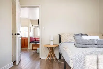 a bedroom with a bed and a small table at 2min2Beach, Netflix, AC, WD,15min2LAX, Fast Wifi in Hermosa Beach