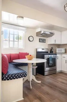 a kitchen with a table and a red couch at 2min2Beach, Netflix, AC, WD,15min2LAX, Fast Wifi in Hermosa Beach
