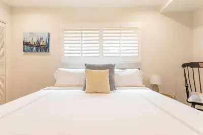 a large white bed in a room with a window at Walk 2 Beach, Parking, AC, WD,15min2LAX,Remodel in Manhattan Beach