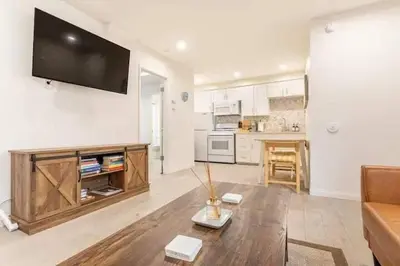 a living room with a couch and a tv on a wall at Walk 2 Beach, Parking, AC, WD,15min2LAX,Remodel in Manhattan Beach