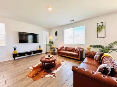 a living room with two couches and a tv at Modern Desert Gem, Boho Retreat 2 Living Rooms in Hesperia
