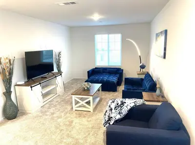 a living room with blue couches and a flat screen tv at Modern Desert Gem, Boho Retreat 2 Living Rooms in Hesperia