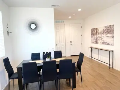a dining room with a table and black chairs at Modern Desert Gem, Boho Retreat 2 Living Rooms in Hesperia