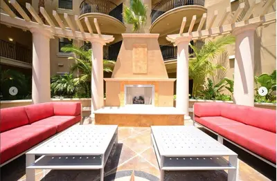 a lobby with two red couches and a fireplace at SoCal Lux on Miramar in Los Angeles