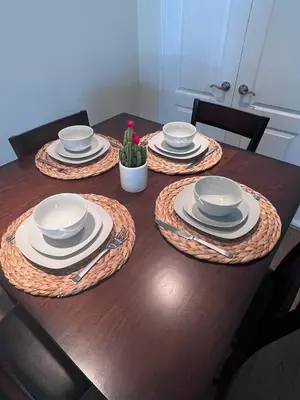 a wooden table with plates and dishes on it at SoCal Lux on Miramar in Los Angeles