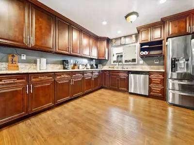 a large kitchen with wooden cabinets and stainless steel appliances at Retreat with Pool in Los Angeles