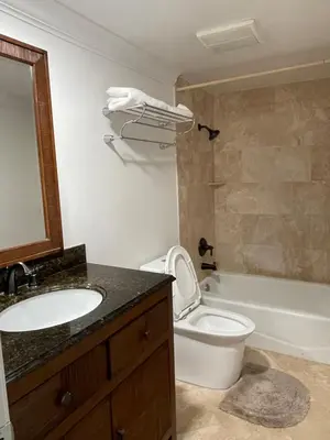 a bathroom with a sink and a toilet and a tub at Central LA GATED Community 4 beds home in Commerce