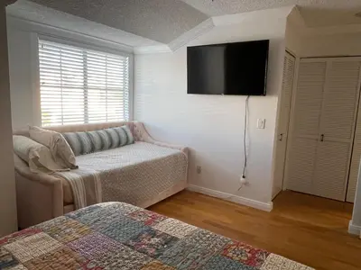 a bedroom with a bed and a flat screen tv at Central LA GATED Community 4 beds home in Commerce