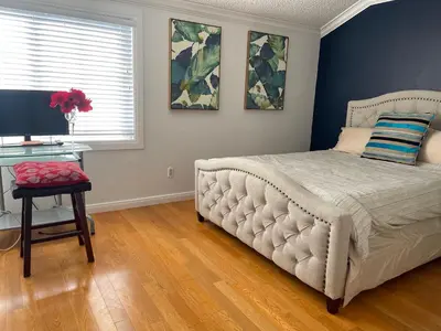 a bedroom with a bed and a desk with a television at Central LA GATED Community 4 beds home in Commerce