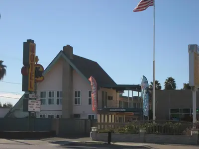 a building with a flag in front of it at Kona Inn Motel Anaheim in Anaheim