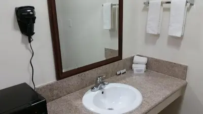 a bathroom with a sink and a mirror at Kona Inn Motel Anaheim in Anaheim