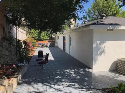 a patio with two chairs and a building at Glendale Hills Hideaway in Glendale