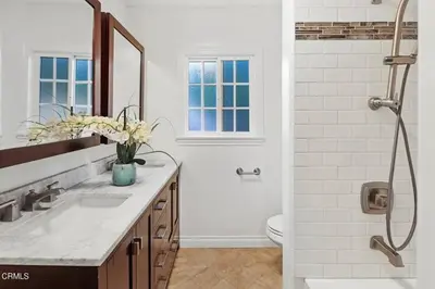 a white bathroom with a sink and a shower at Glendale Hills Hideaway in Glendale