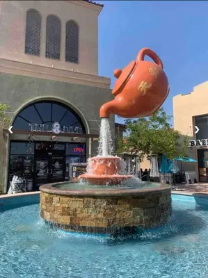 a fountain in front of a shopping center with a pitcher at Sunrise Room 1 guest only near DTLA in San Gabriel