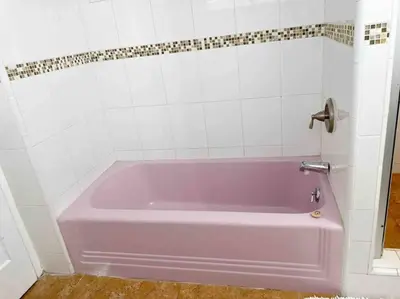 a pink bath tub in a white tiled bathroom at Sunrise Room 1 guest only near DTLA in San Gabriel