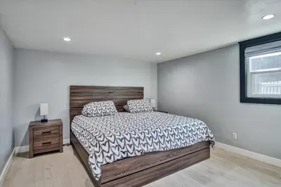 a bedroom with a large bed and a window at Ventura Downtown Minutes to Beaches in Ventura