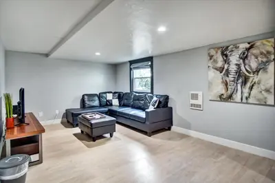 a living room with a couch and a table at Ventura Downtown Minutes to Beaches in Ventura