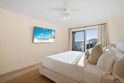 a white bedroom with a large bed and a window at Aquamarine Best View in Malibu by Stay Awhile Villas in Malibu Beach