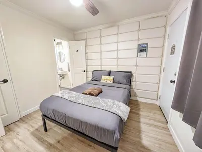 a small bedroom with a bed in the corner at Cozy 2B1B Guest House with Private Entrance and Parking in El Monte