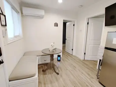 a small white room with a table and a refrigerator at Cozy 2B1B Guest House with Private Entrance and Parking in El Monte