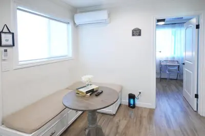a room with a couch and a table with a window at Cozy 2B1B Guest House with Private Entrance and Parking in El Monte