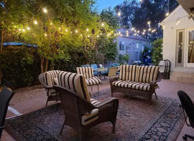 a patio with four chairs and a table with lights at Private guest studio 5 minutes to Rodeo Drive and in great area in Los Angeles