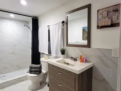 a bathroom with a sink and a toilet and a mirror at Private guest studio 5 minutes to Rodeo Drive and in great area in Los Angeles