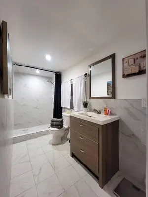 a bathroom with a sink and a toilet and a mirror at Private guest studio 5 minutes to Rodeo Drive and in great area in Los Angeles