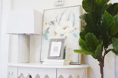 a white shelf with a picture and a plant at Spacious 3BR Modern Home in LA Perfect for Family in El Monte