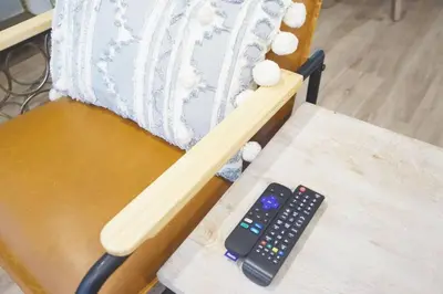 a chair with two remote controls on a table at Spacious 3BR Modern Home in LA Perfect for Family in El Monte