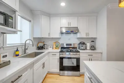 a kitchen with white cabinets and a stove top oven at Spacious 3BR Modern Home in LA Perfect for Family in El Monte