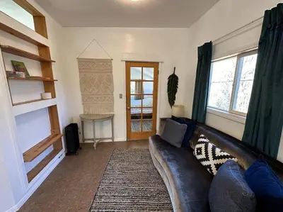 a living room with a couch and a table at Topanga Panoramic View Loft with Trails & Creeks in Topanga