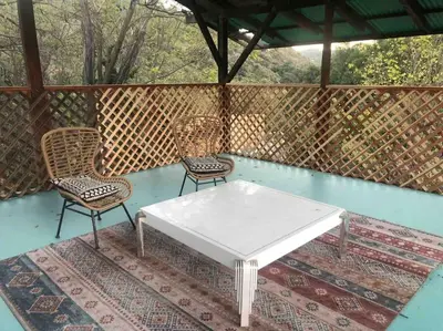 two chairs and a white table on a patio at Topanga Panoramic View Loft with Trails & Creeks in Topanga