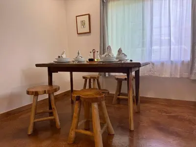 a wooden table with stools in a room at Vacation House in Ontario - Two Bedroom Brand New and Hand Made Furniture in Ontario