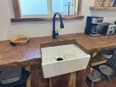 a kitchen counter with a white sink in it at Vacation House in Ontario - Two Bedroom Brand New and Hand Made Furniture in Ontario