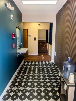a hallway with a black and white tile floor at Star Inn Hotel in Maywood