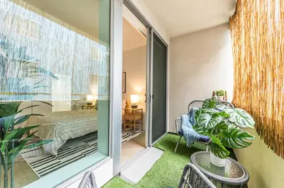 a room with a bedroom with a bed and a window at Stylish 2BDR & 2BTH - 15 mins walk to the beach! in Los Angeles